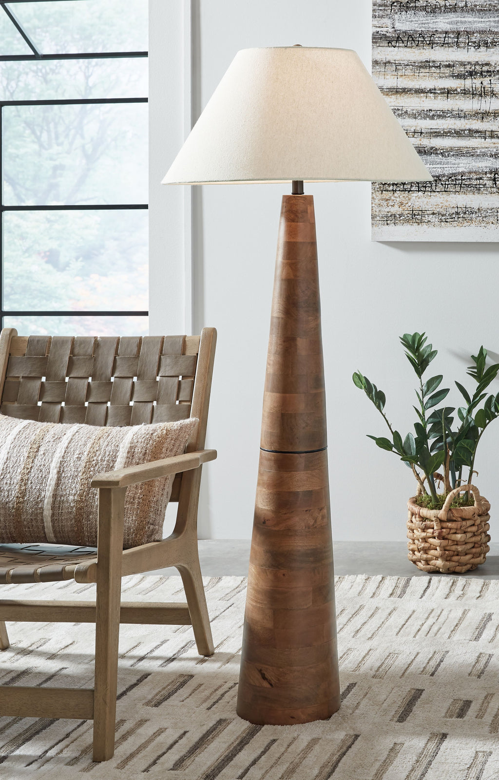 Wood floor lamp with cream fabric shade and dark brown stacked-ring wooden base