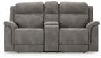 Dark gray reclining power loveseat with central console panel and padded armrests