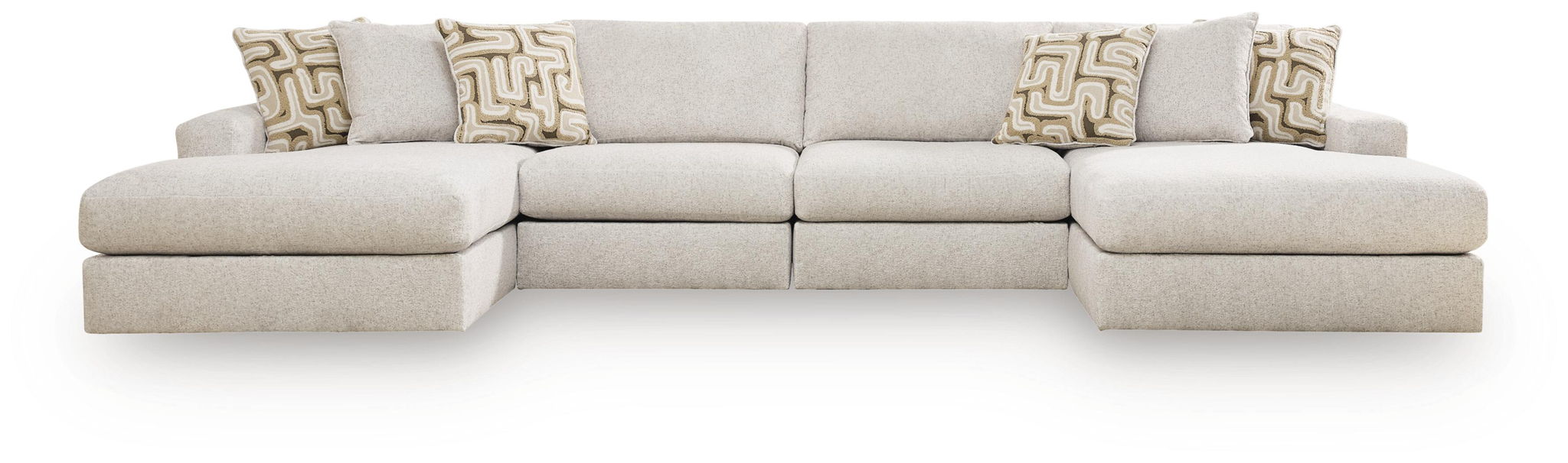 Light beige sectional sofa with multiple seat sections and patterned throw pillows.
