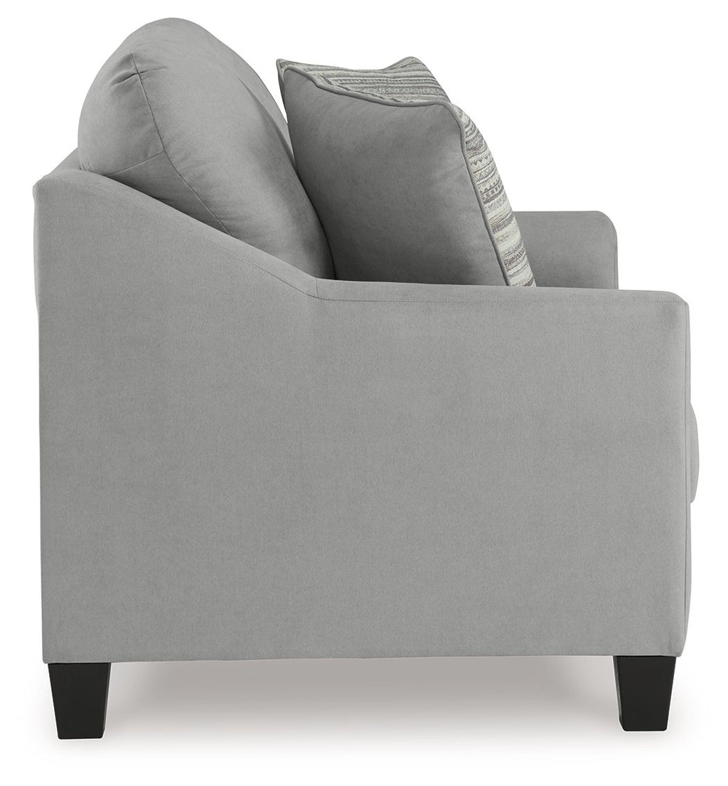 Gray loveseat with curved arms and a striped accent pillow on the backrest