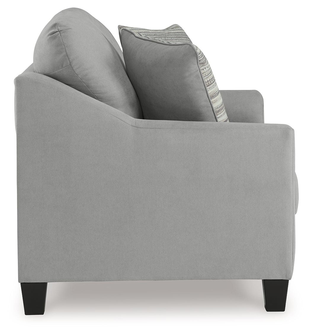 Gray loveseat with curved arms and a striped accent pillow on the backrest