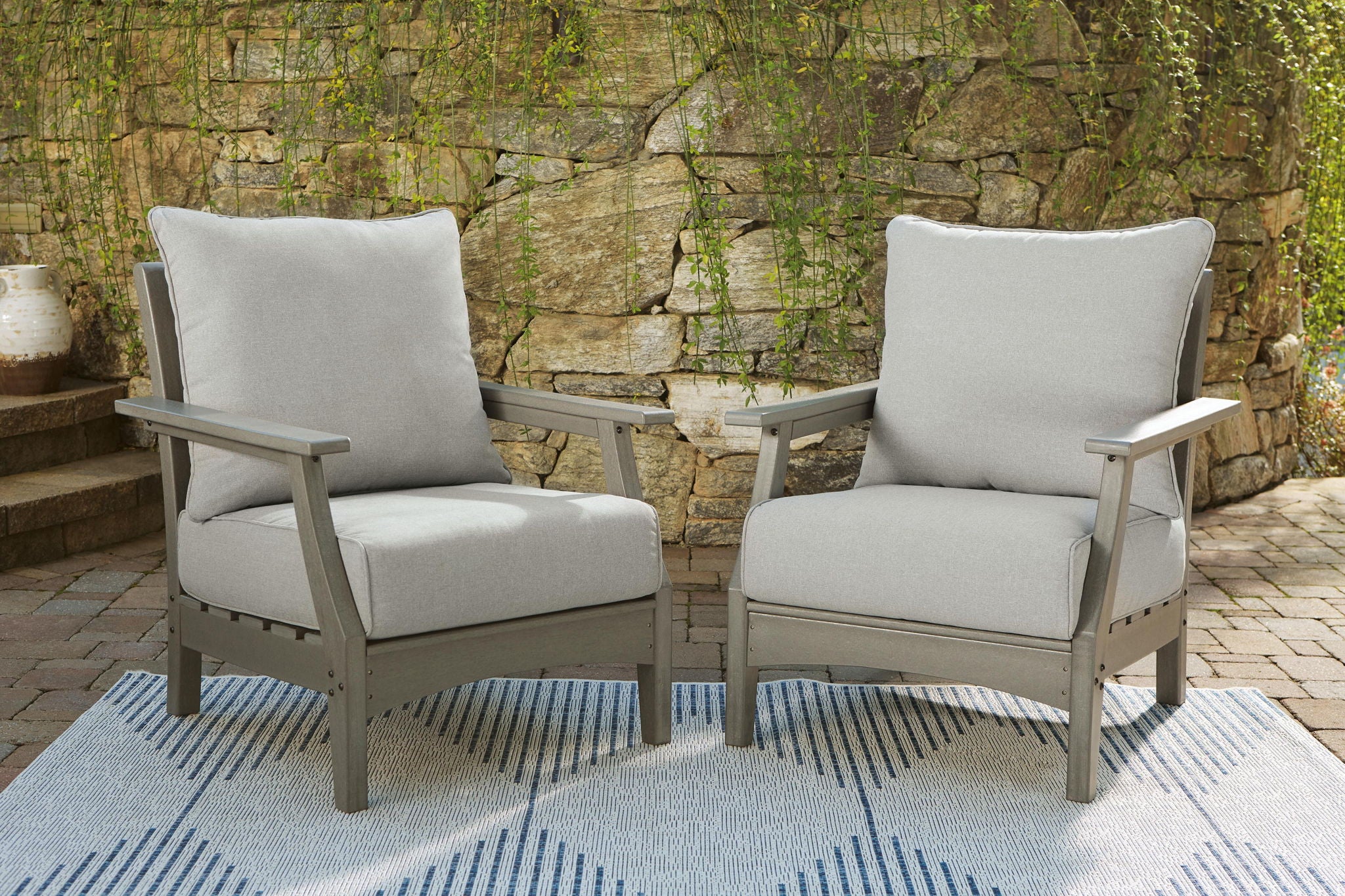 Set of 2 gray lounge chairs with padded seat and tall back cushions, wood frame
