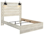 Beige panel bed with paneled headboard, open footboard, and dark metal support frame