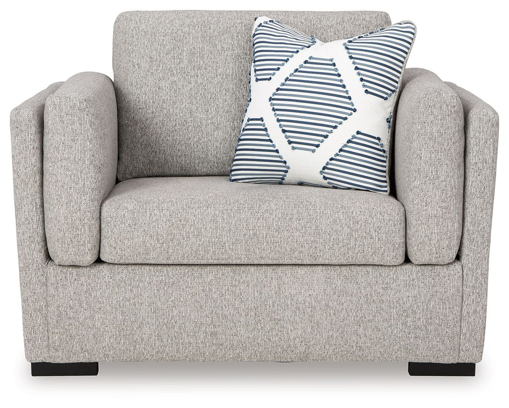 Gray armchair with curved arms and a striped throw pillow