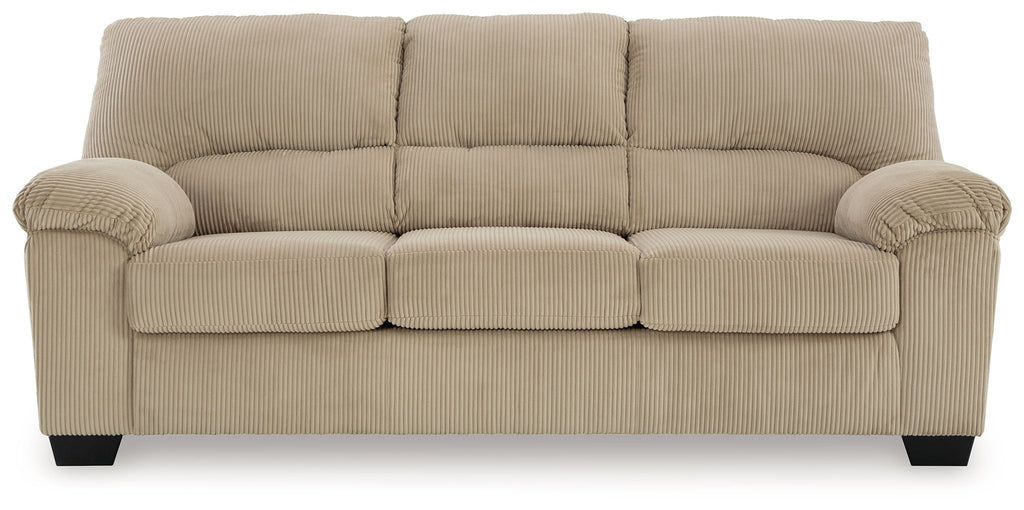 Beige upholstered sofa with padded armrests, tufted back cushions, and square legs.