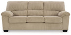 Beige upholstered sofa with padded armrests, tufted back cushions, and square legs.