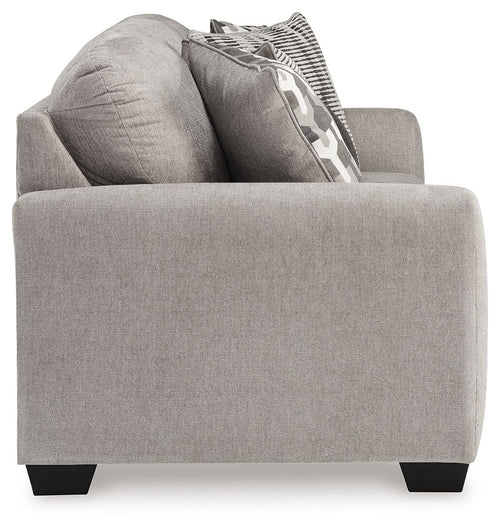 Gray flannel sofa with side arm, two back pillows, and geometric throw