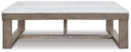 Rectangular cocktail table with white marble-look top and brown wood frame, open shelf.