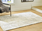 Cream distressed area rug with short, low-pile texture and gray speckling