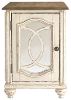 Whitewashed chair side end table with inset oval mirror door and black knob