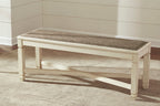 Upholstered dining bench with beige frame and dark fabric cushion top