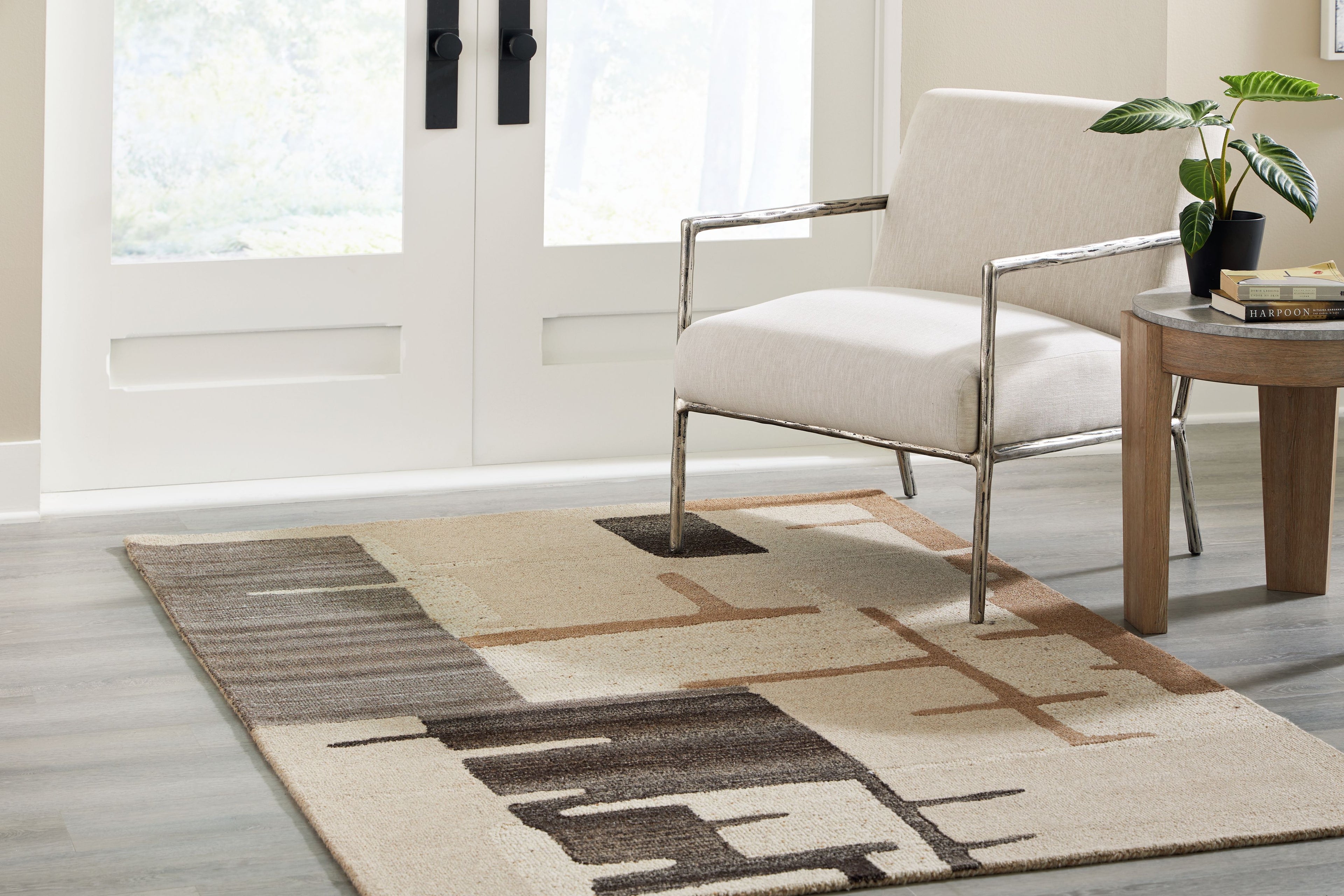 Abstract beige area rug with dark brown geometric stripes and block accents