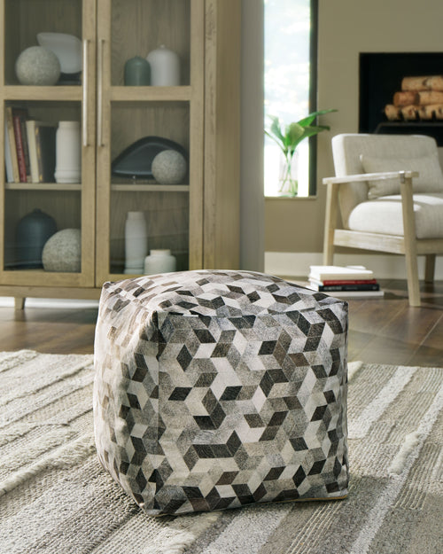 Geometric fabric pouf ottoman in gray, black, and off-white cube pattern
