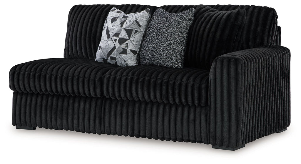 Dark velvet right-facing sofa with ribbed arms and back, plus two throw pillows