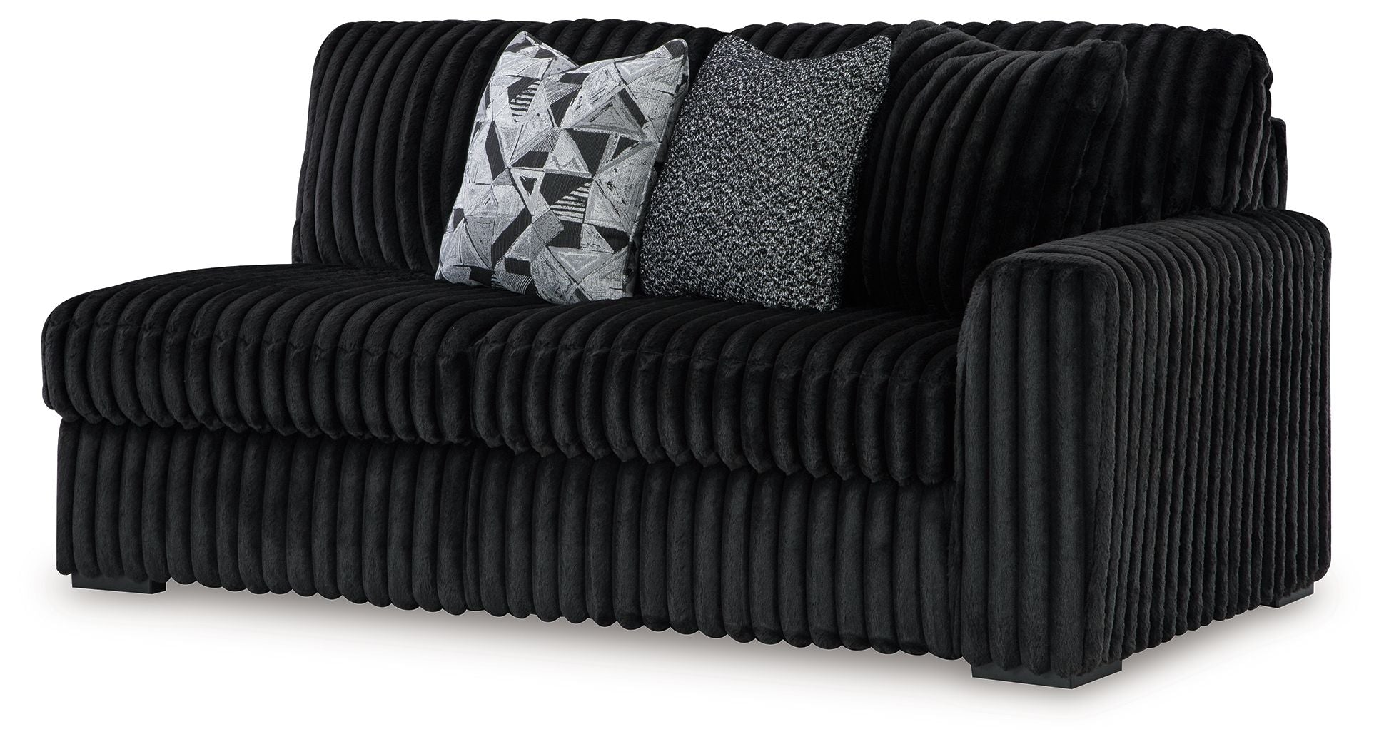 Dark velvet right-facing sofa with ribbed arms and back, plus two throw pillows