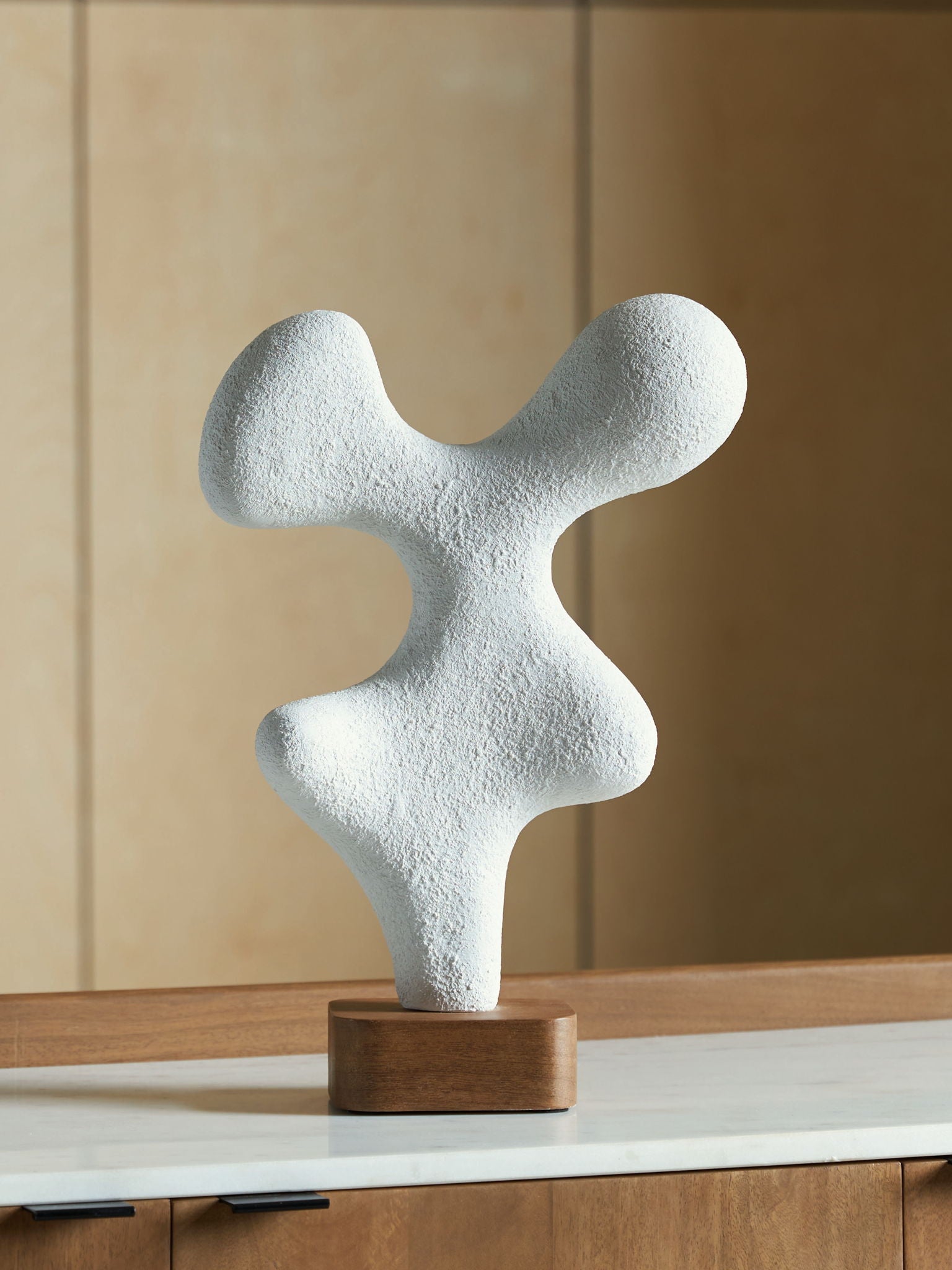 Lavarsen white abstract sculpture standing on a square wooden base