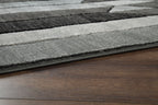 Dark gray and light gray geometric area rug edge with flat woven border