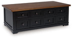Brown lift-top cocktail table with black drawer fronts and metal knobs
