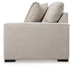 Sand fabric loveseat arm and back cushions with textured decorative pillows