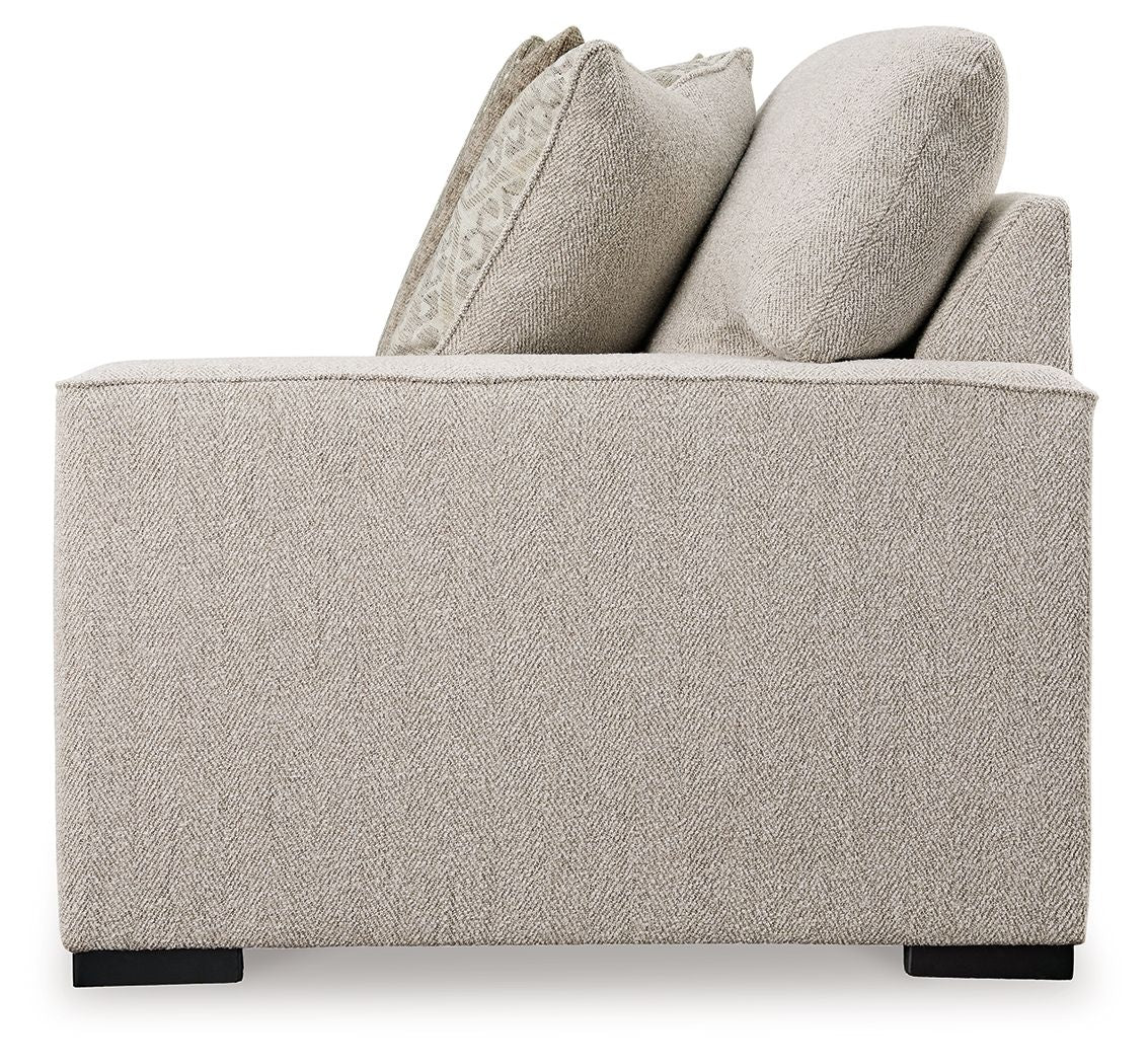 Sand fabric loveseat arm and back cushions with textured decorative pillows