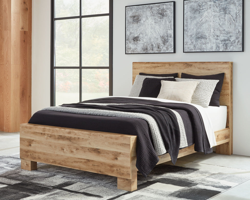 Light beige panel bed with dark striped throw, white duvet, and decorative pillows