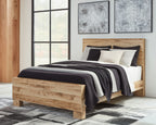Light beige panel bed with dark striped throw, white duvet, and decorative pillows