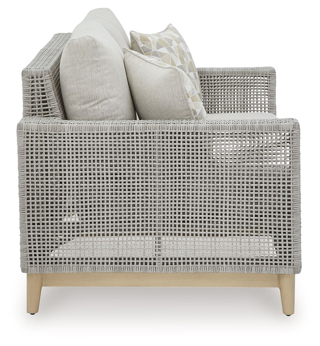Gray woven loveseat with back cushions, two seat cushions, and two patterned pillows