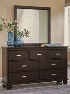 Dark brown dresser with tall rectangular mirror and nine drawers, silver bar handles.