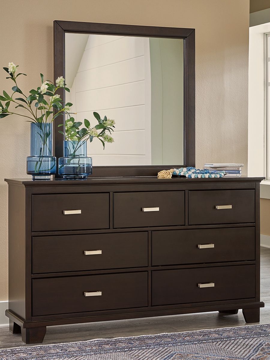 Dark brown dresser with tall rectangular mirror and nine drawers, silver bar handles.
