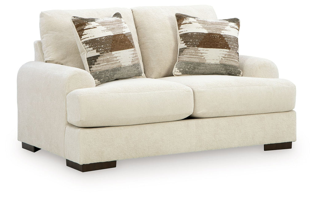 Light cream loveseat sofa with two seat cushions, square arms, dark legs, patterned pillows