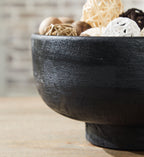 Brynnington black bowl, side view with rustic mottled texture and pedestal base