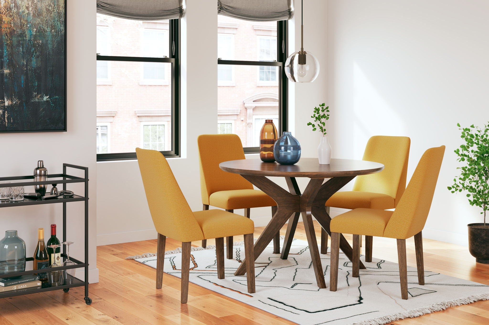 Dining table set with round wood table and four yellow upholstered chairs