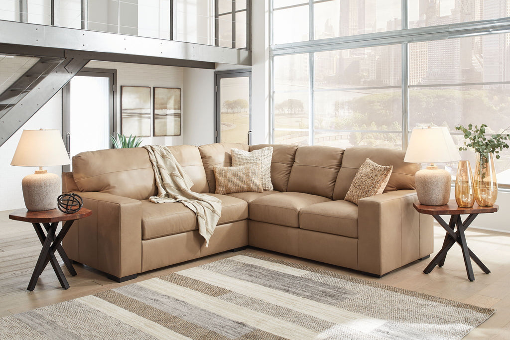 Light brown fabric sectional sofa with chaise and matching ottoman, throw pillows included