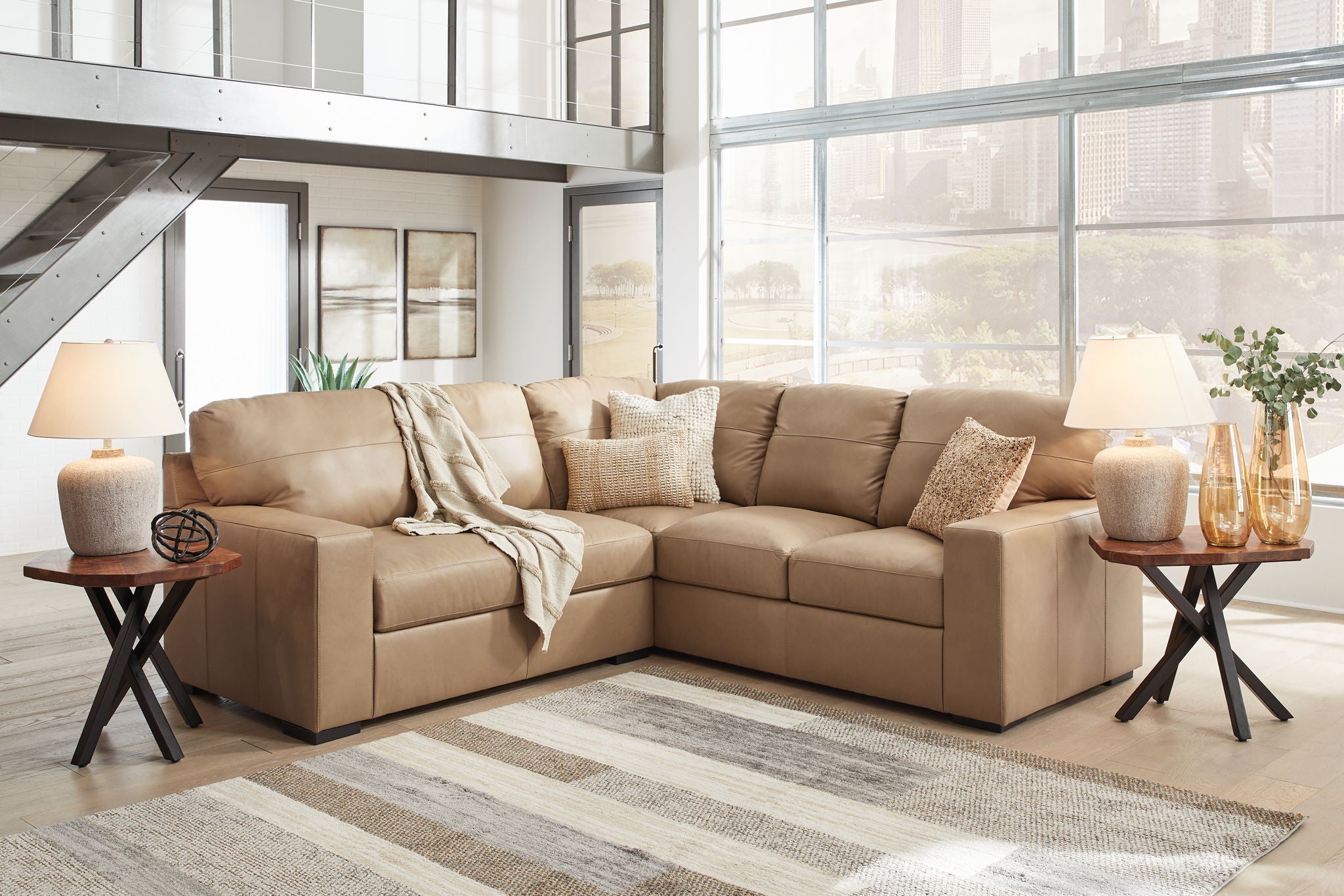 Light brown fabric sectional sofa with chaise and matching ottoman, throw pillows included