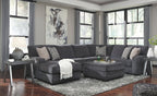 Dark gray sectional sofa with chaise and accent ottoman, patterned throw pillows