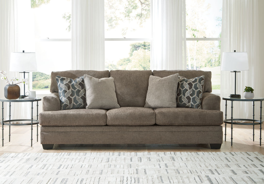 Stonemeade sofa in dark taupe with four accent pillows, including two geometric cushions