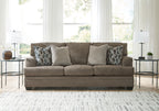 Stonemeade sofa in dark taupe with four accent pillows, including two geometric cushions