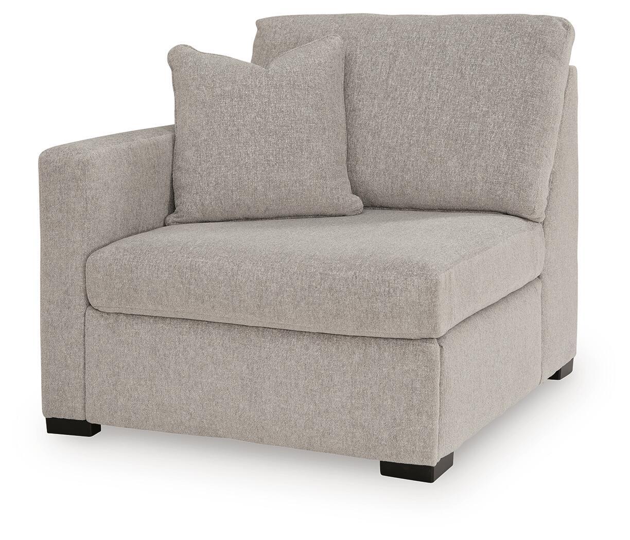 Grey upholstered corner chair with tall back and seat cushion, black feet