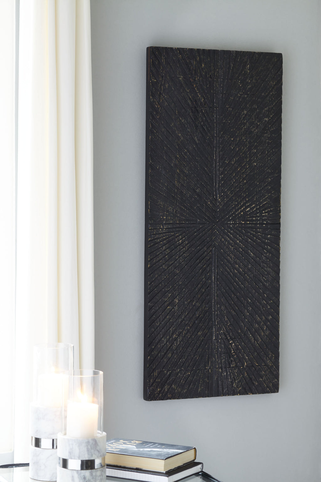 Antique black wall decor panel with textured crosshatch and central starburst lines