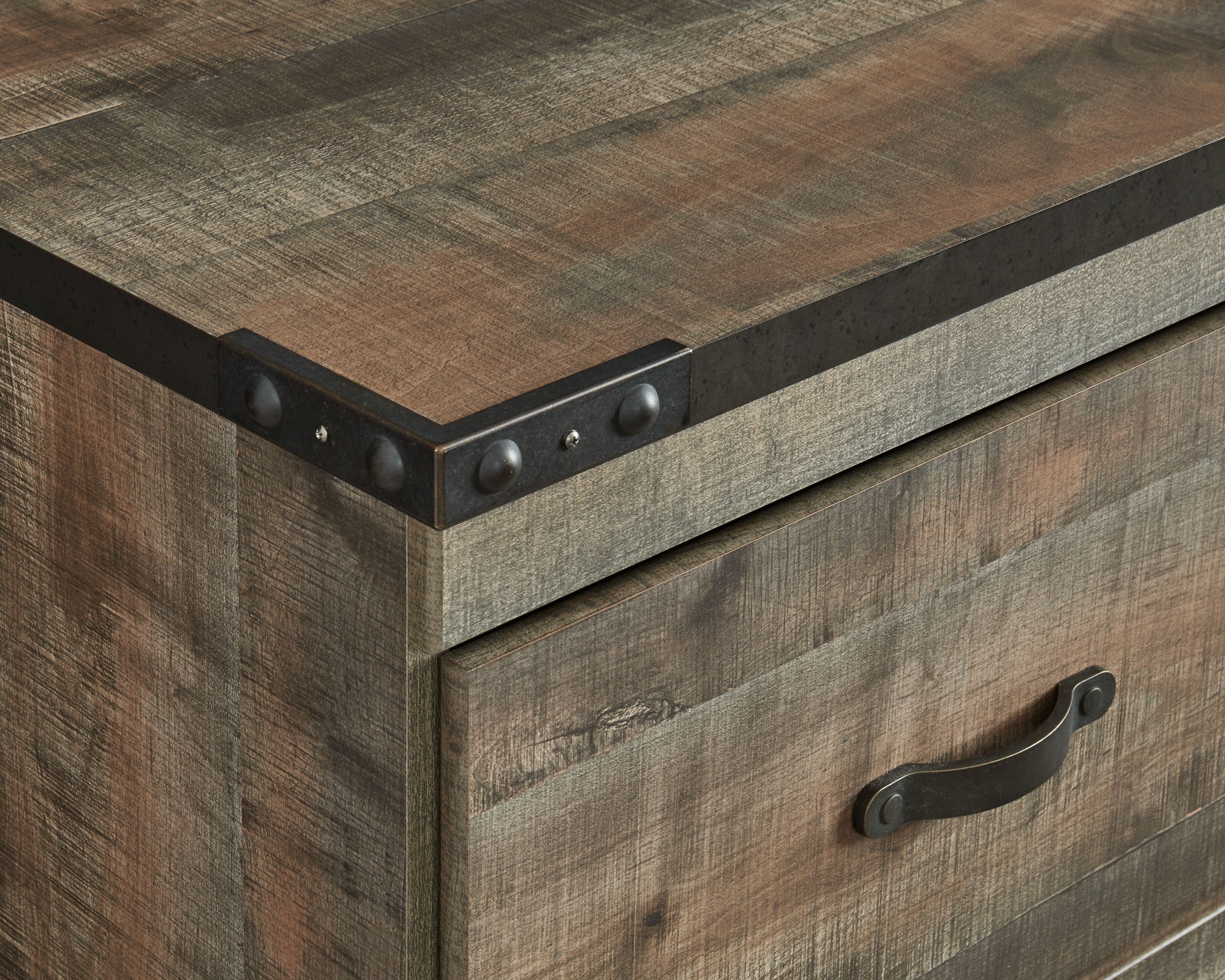Brown wood drawer front with metal handle and dark corner brackets