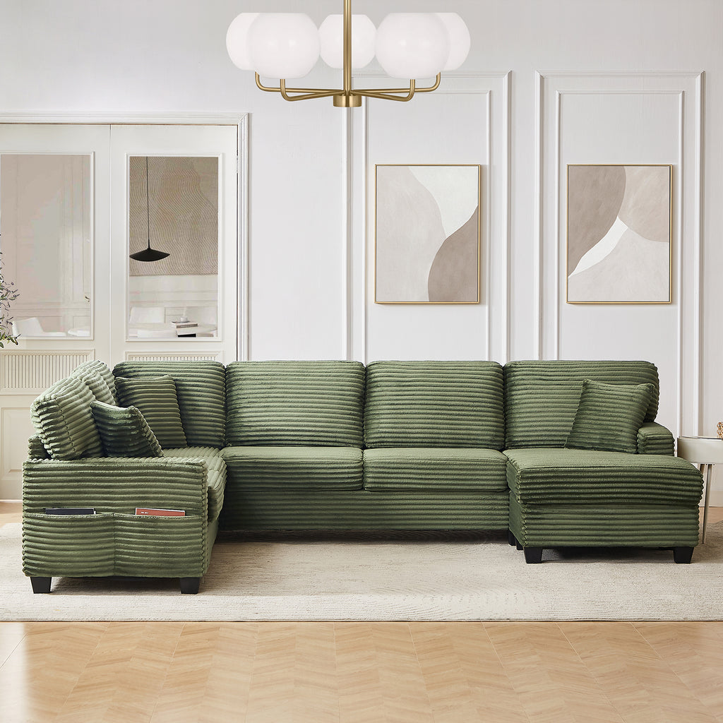Green corduroy U-shaped sectional sofa with chaise, toss pillows, and ottoman side