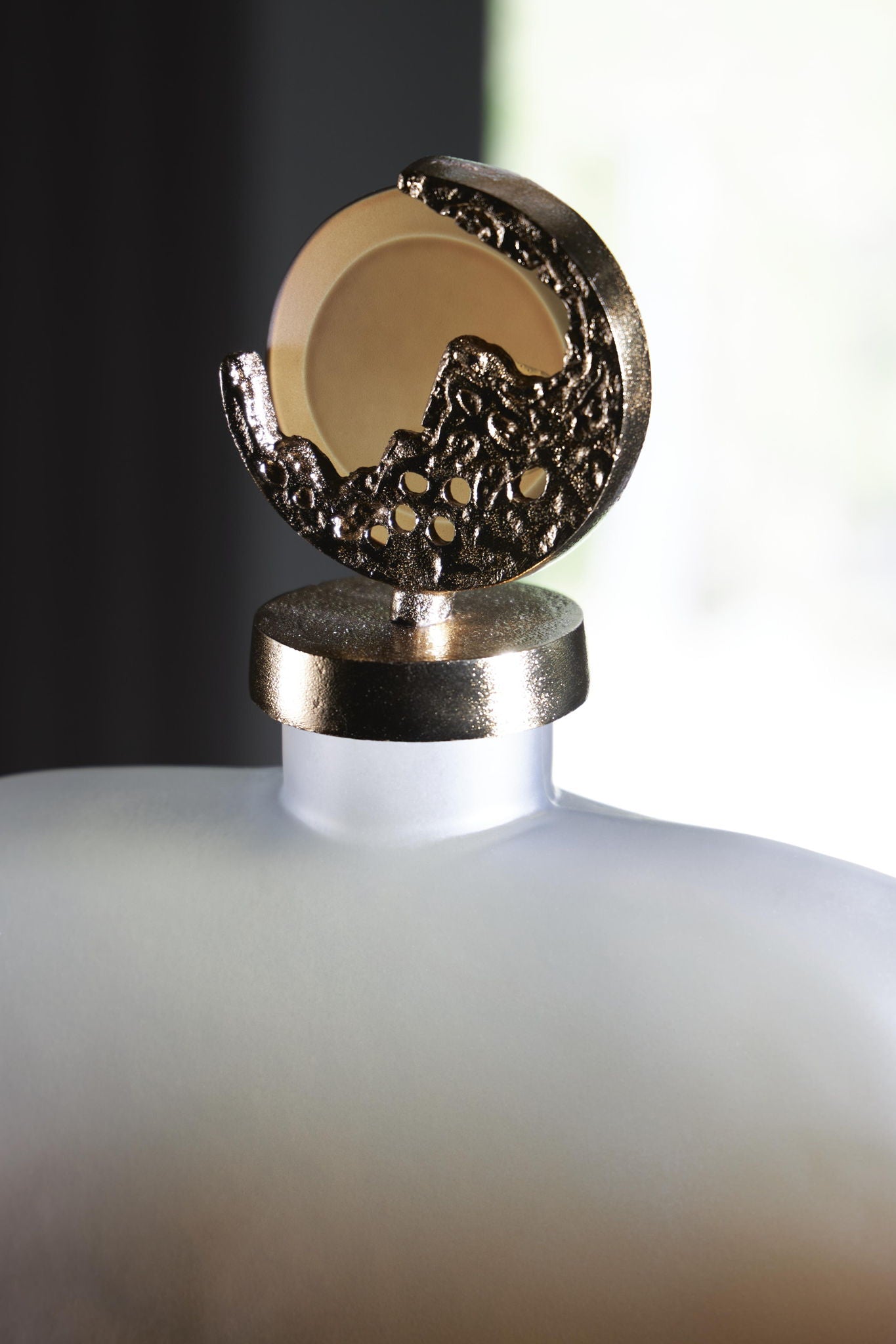 Decorative jar lid finial detail in gold-tone with ornate hinged mount