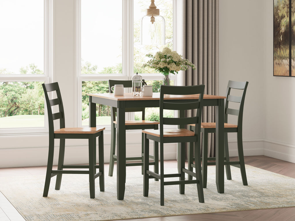 Dark wood dining table with four dark green chairs, slatted backs and square seats