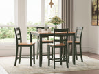 Dark wood dining table with four dark green chairs, slatted backs and square seats
