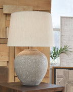 Paper table lamp with beige drum shade and distressed gray rounded base