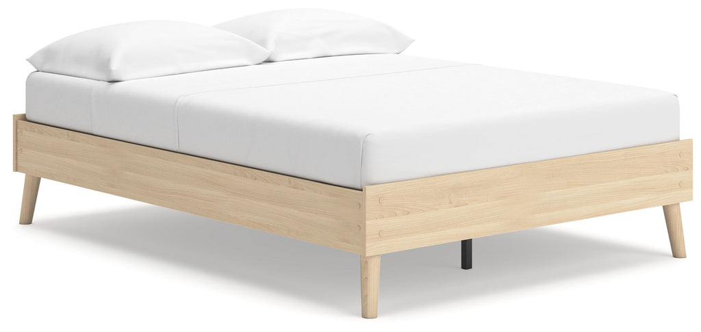 Platform bed with light wood frame and white upholstered headboard, side rails, legs