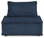 Blue ribbed accent chair, side view with tufted high back and padded seat