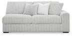 Light gray upholstered sofa with ribbed upholstery and two lumbar pillows