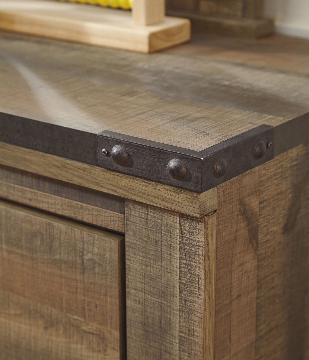 Brown five-drawer chest corner detail with metal pull and distressed wood top