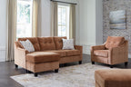 Brown sectional sofa with chaise and two patterned pillows, plus matching accent chair